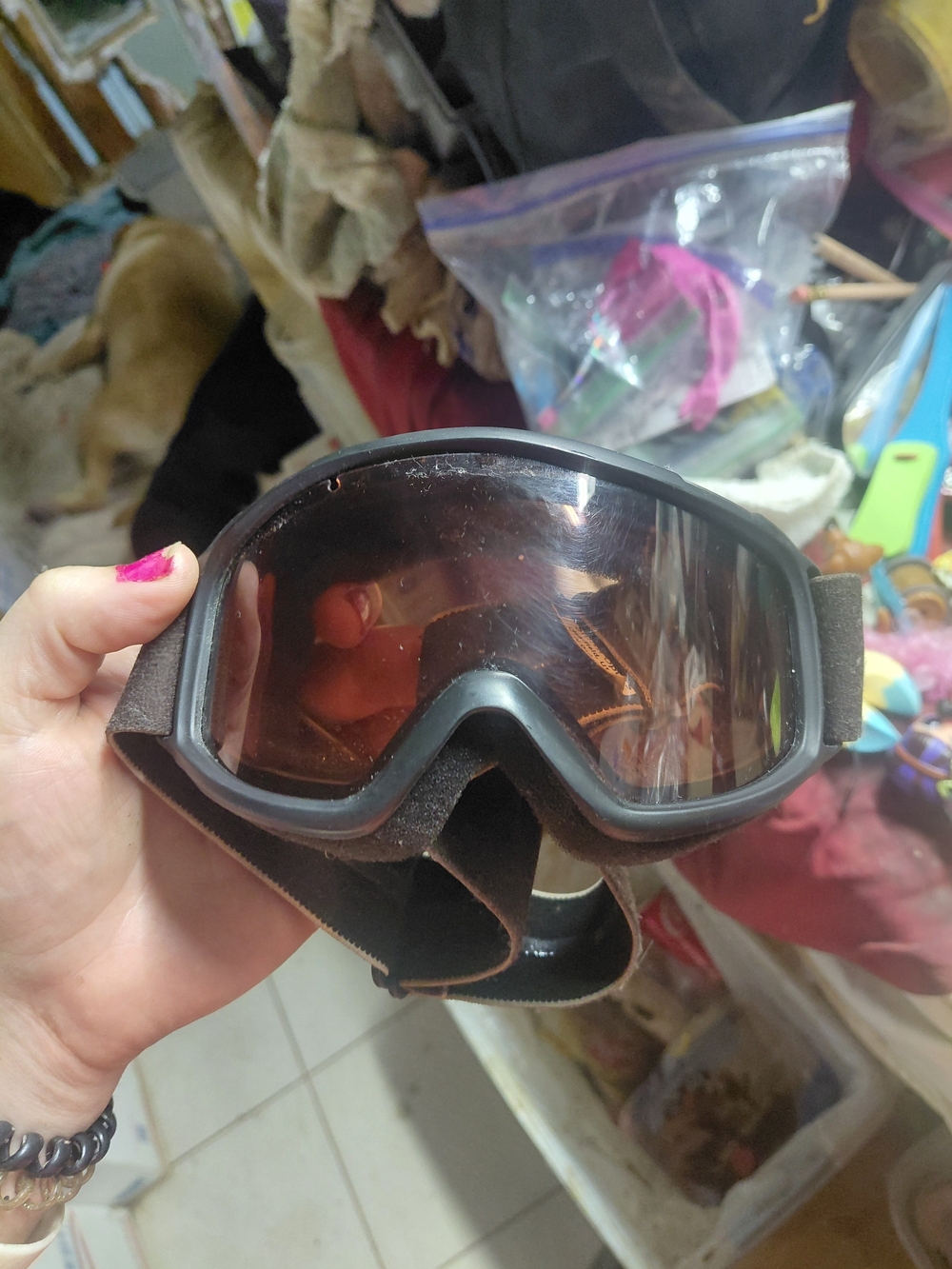 pair of black ski or snowboarding goggles with an adjustable elastic strap